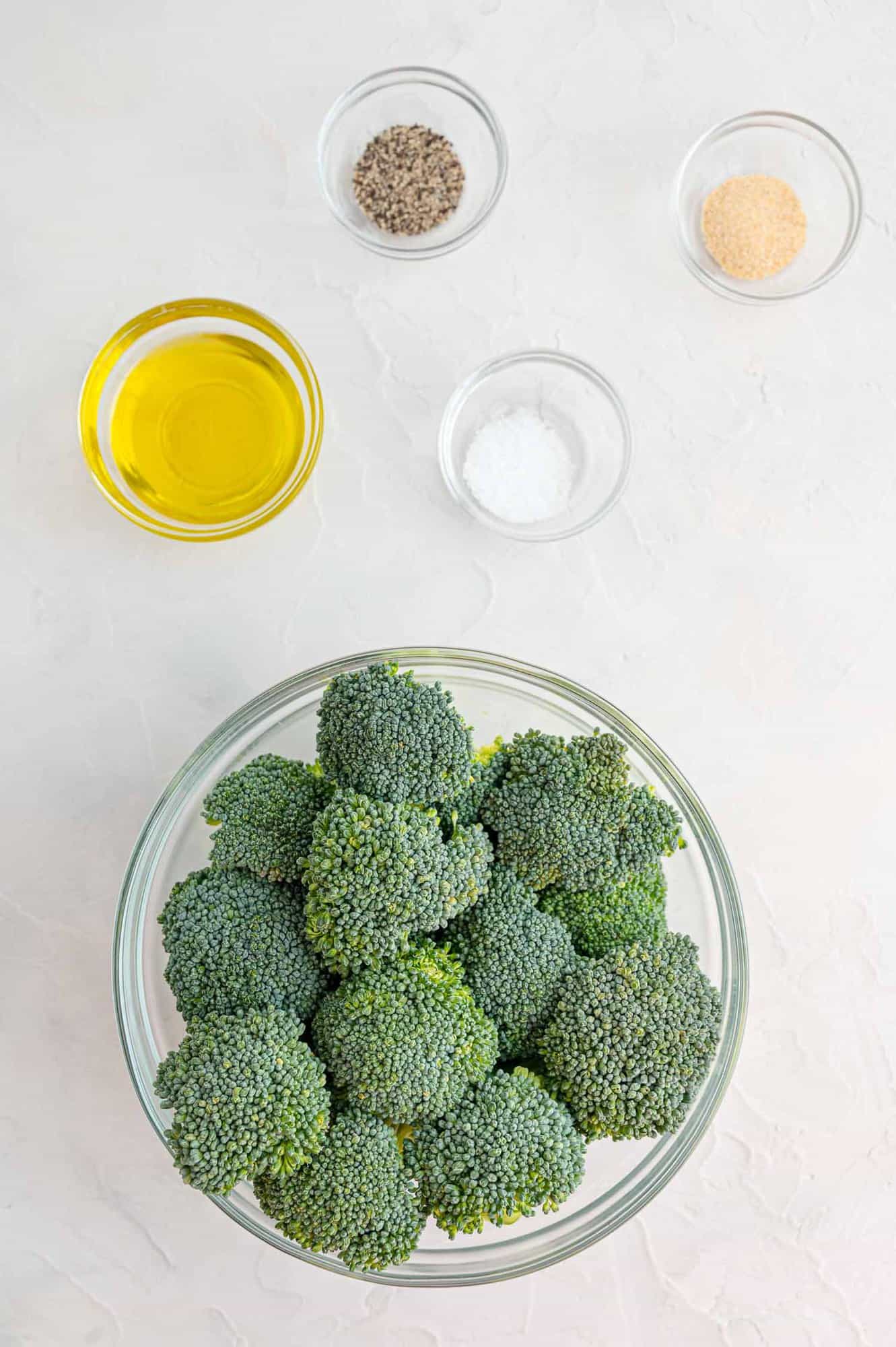 Ingredients in separate bowls including broccoli.