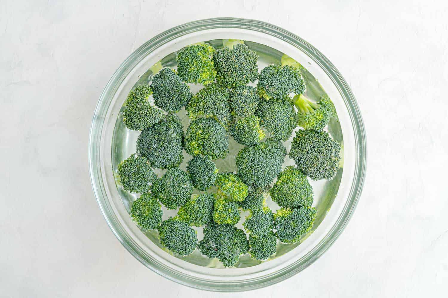 Broccoli in a bowl of water.