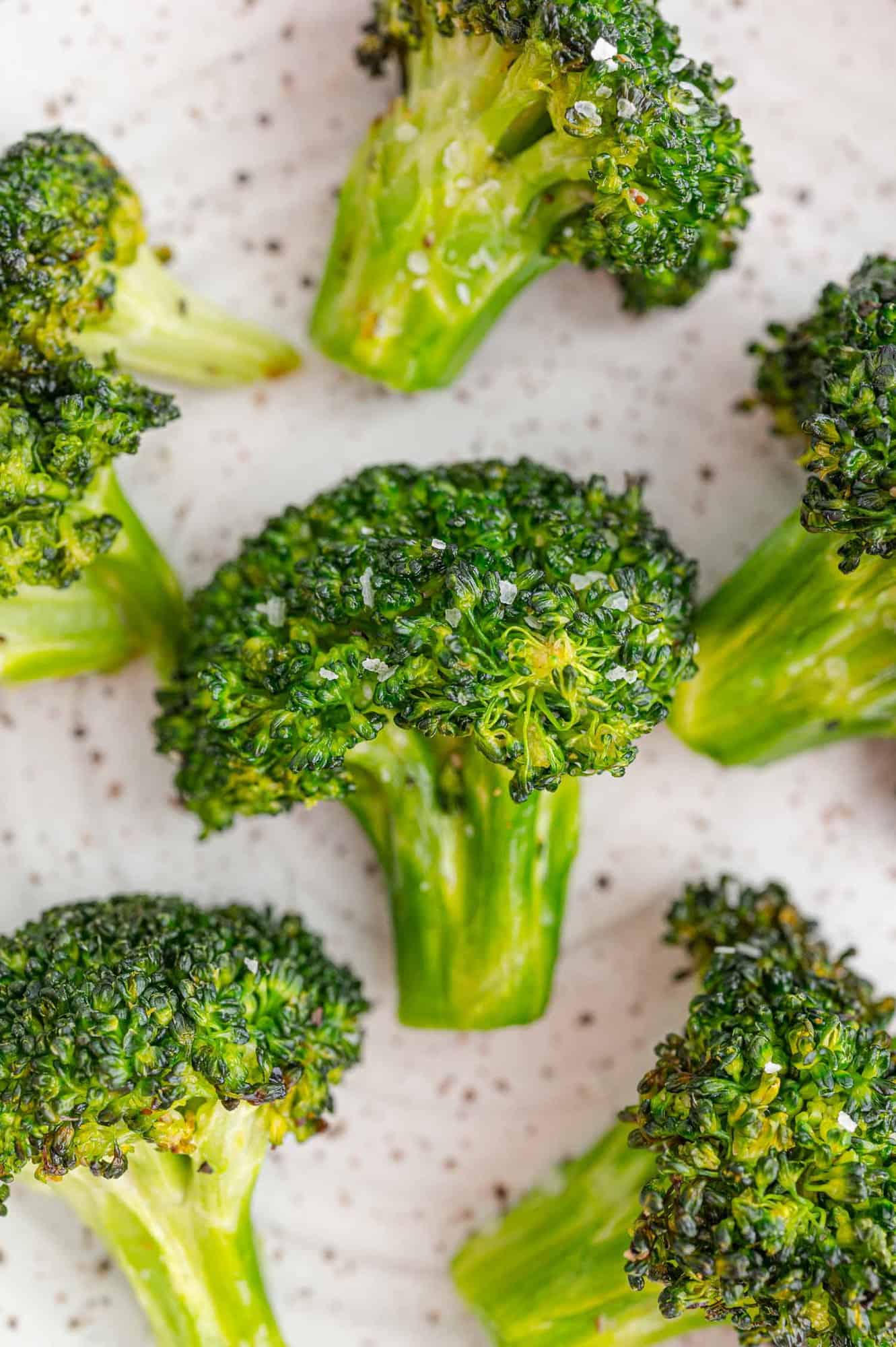 Cooked broccoli on a white background.