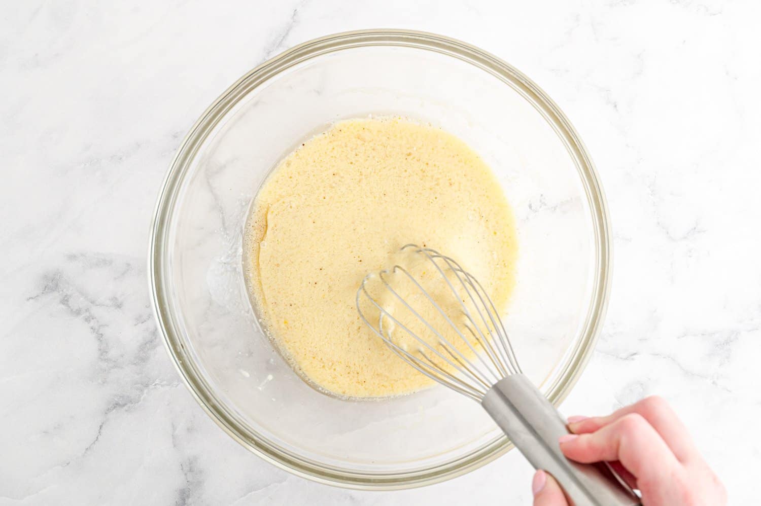 Wet ingredients in mixing bowl with whisk.