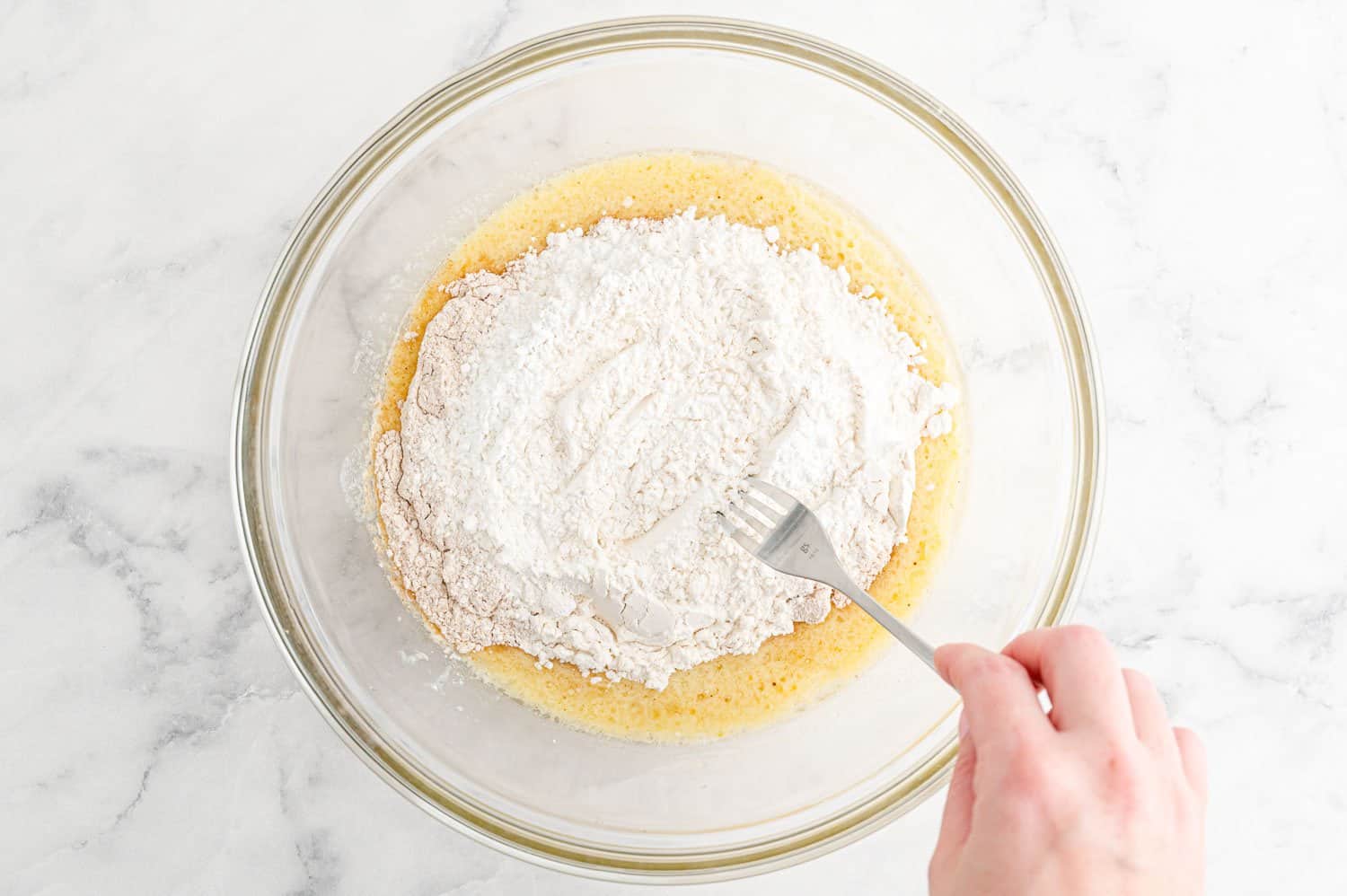 Dry ingredients being mixed before stirring into wet ingredients.