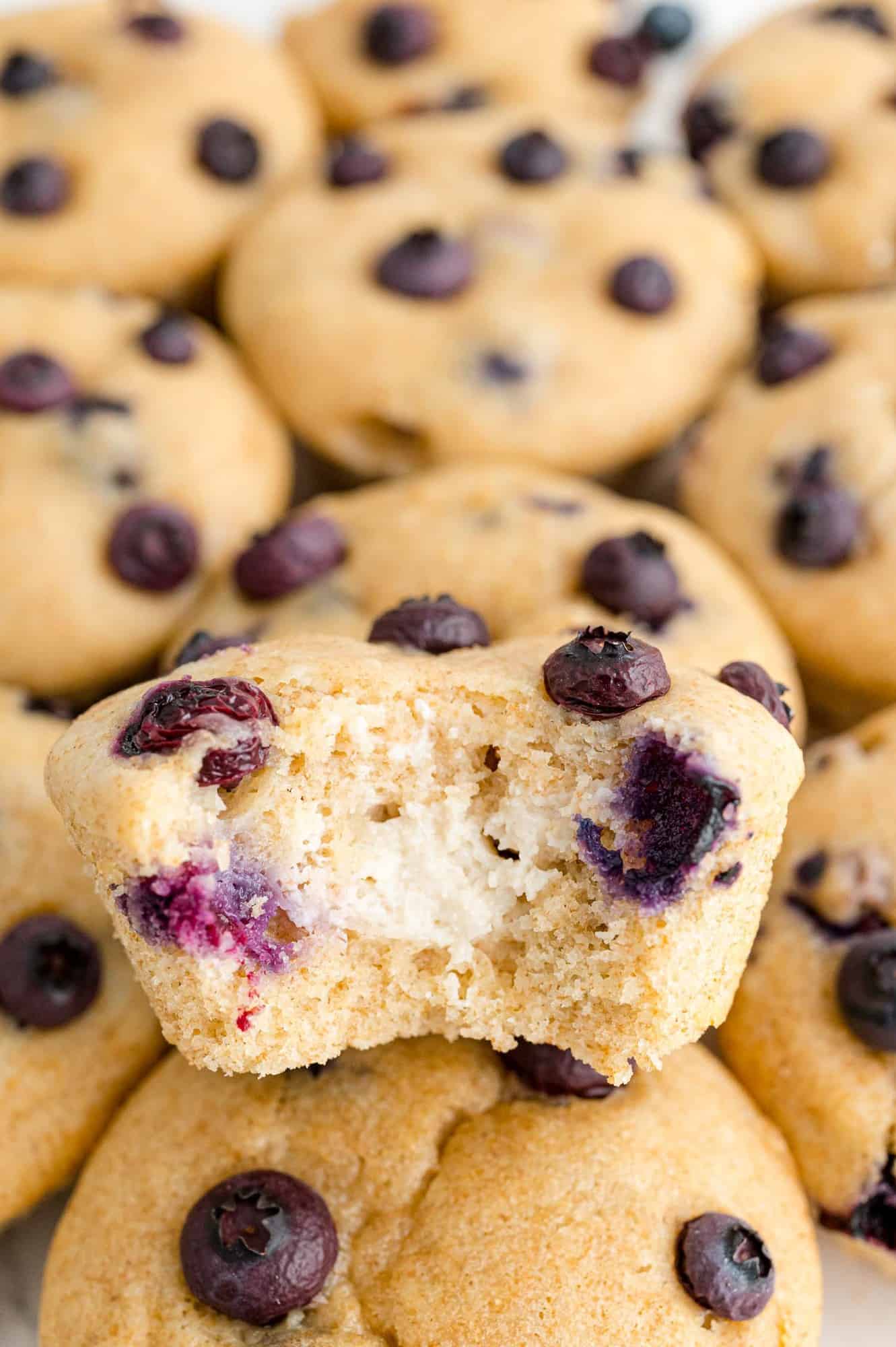 Blueberry cream cheese muffin on top of other muffins.