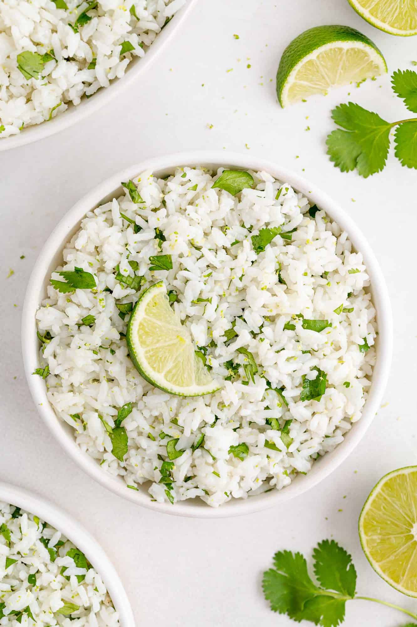 Cilantro lime rice in a round white bowl.