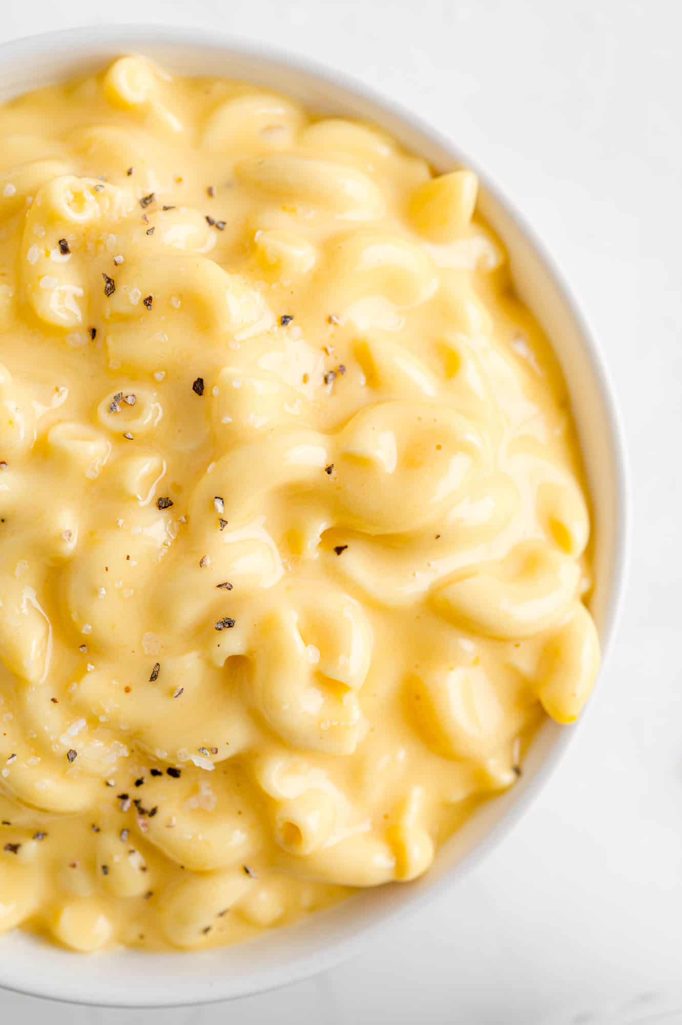 Close up of macaroni and cheese in white bowl.