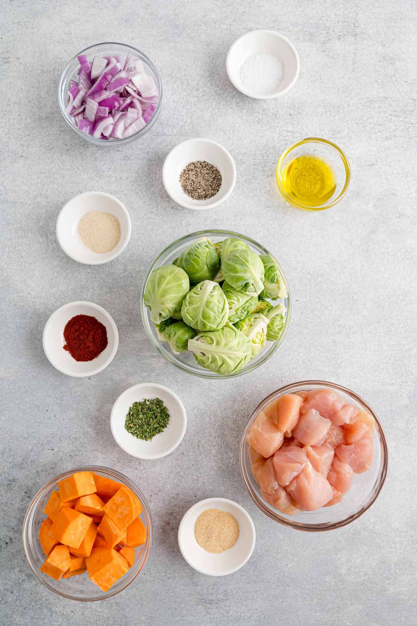 Ingredients needed for recipe including chicken, Brussels sprouts, sweet potatoes.