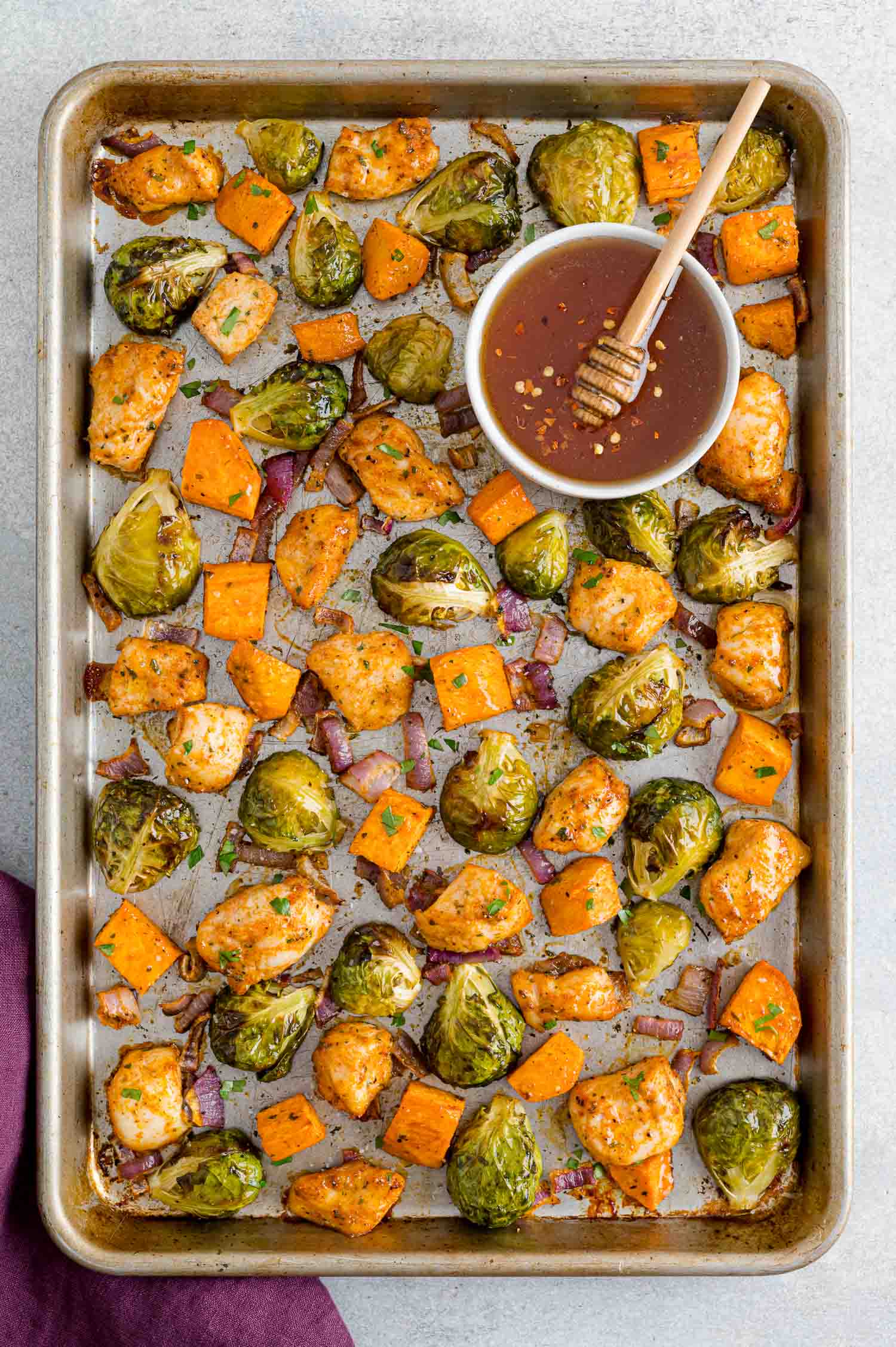 Hot honey sheet pan chicken dinner with brussels sprouts.