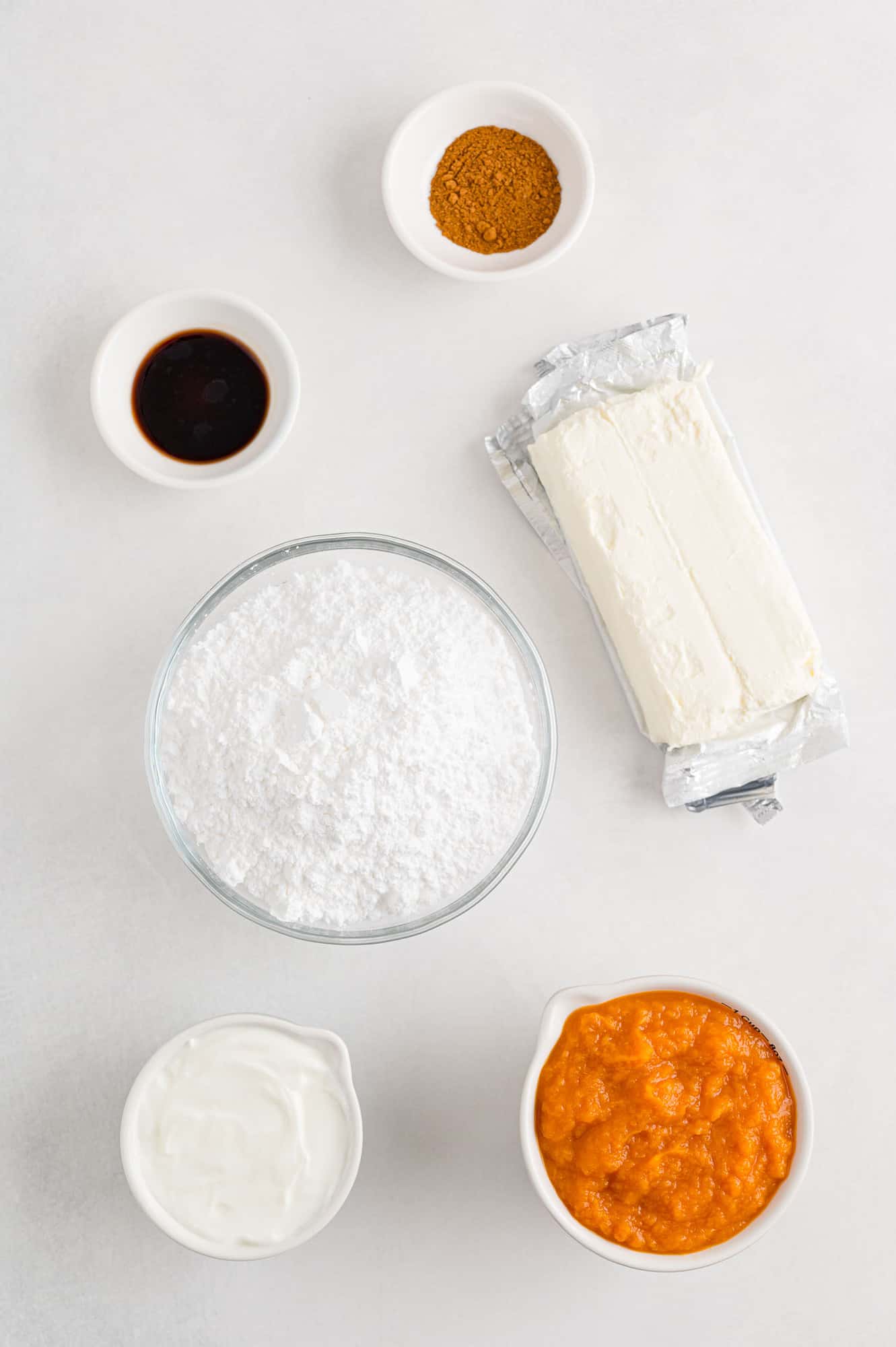 Ingredients for pumpkin dip, including pumpkin puree and cream cheese dip.