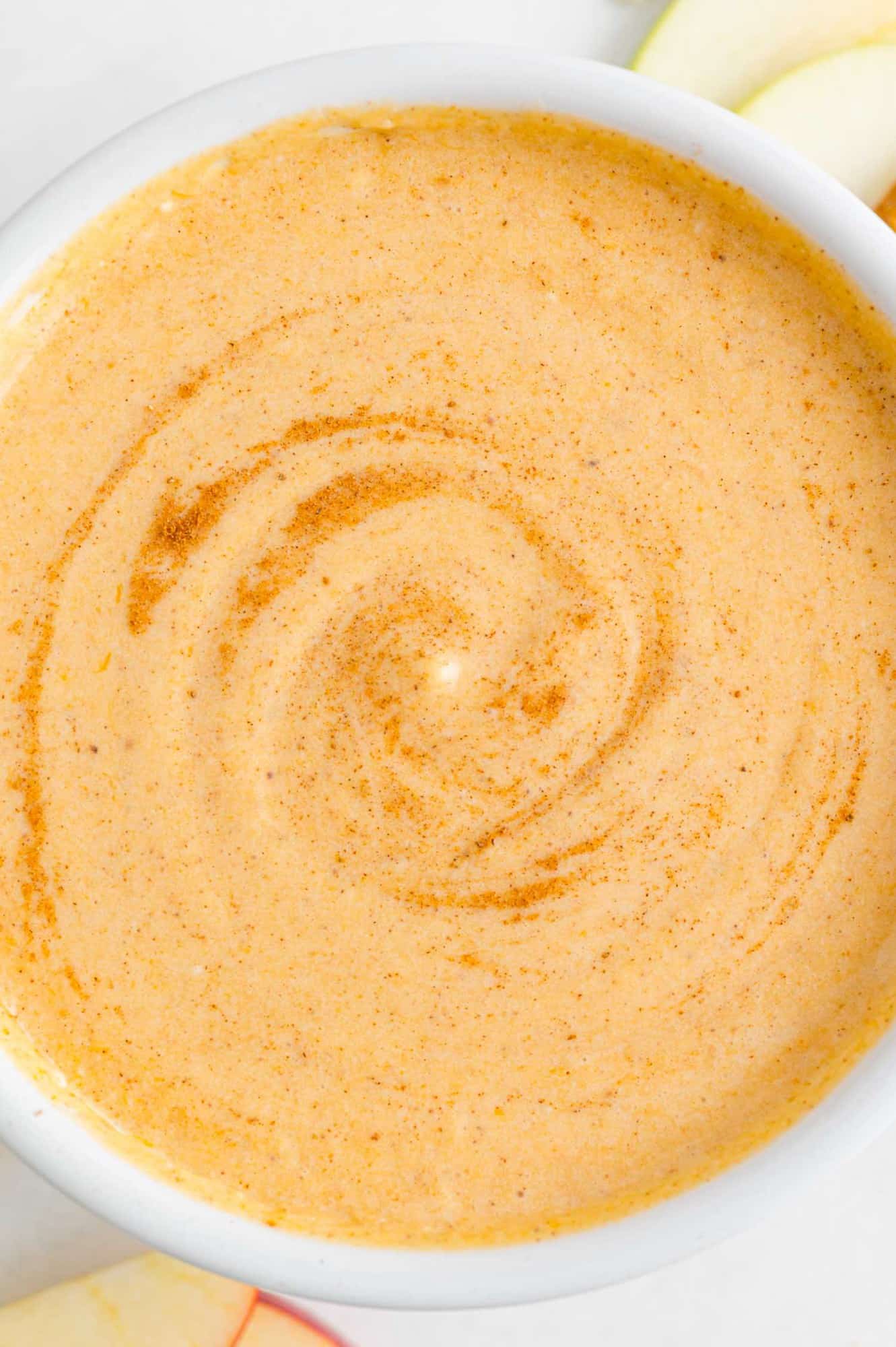 Pumpkin dip in a large white bowl.