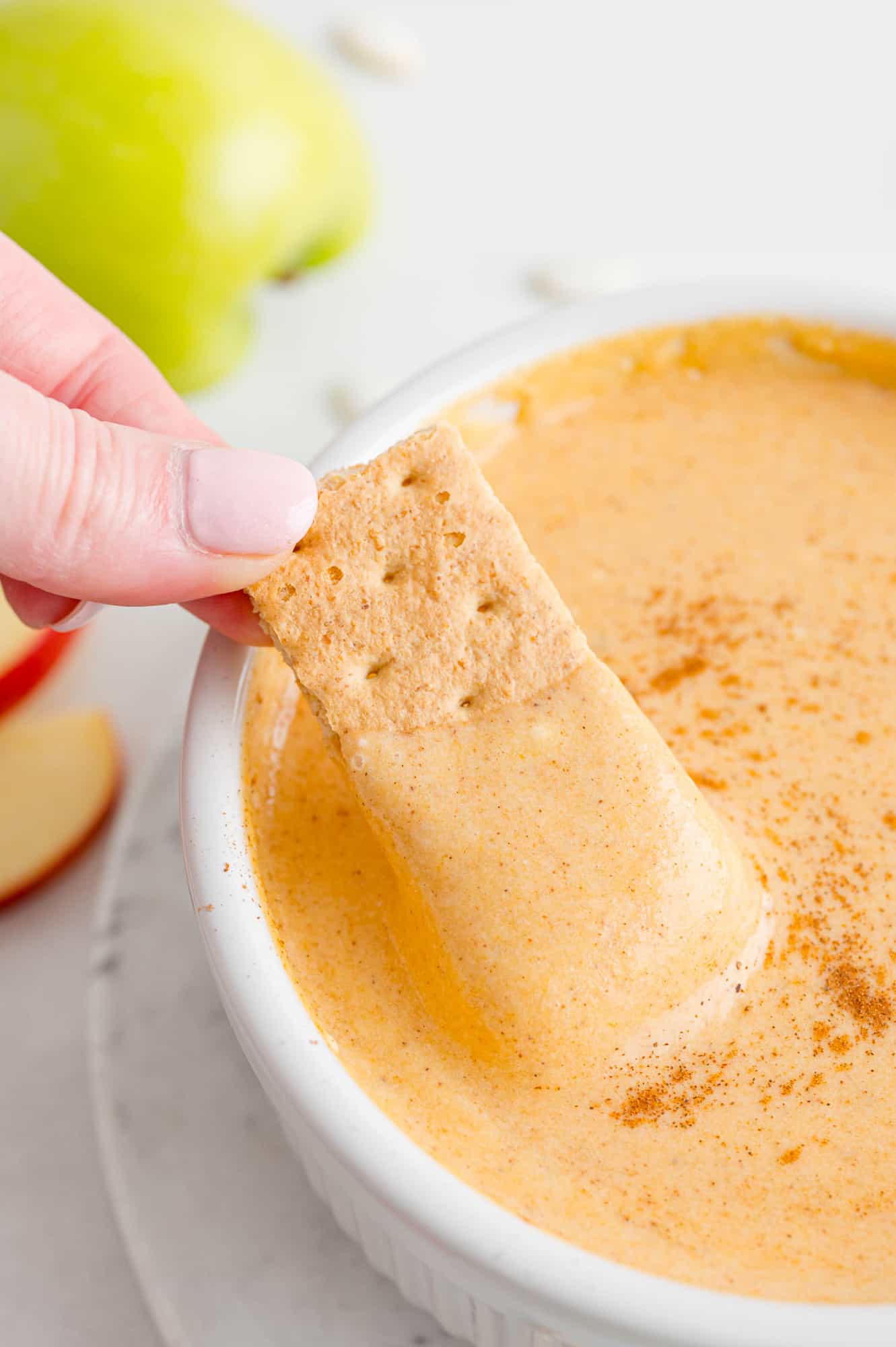 Pumpkin pie dip with a graham cracker dipped in.