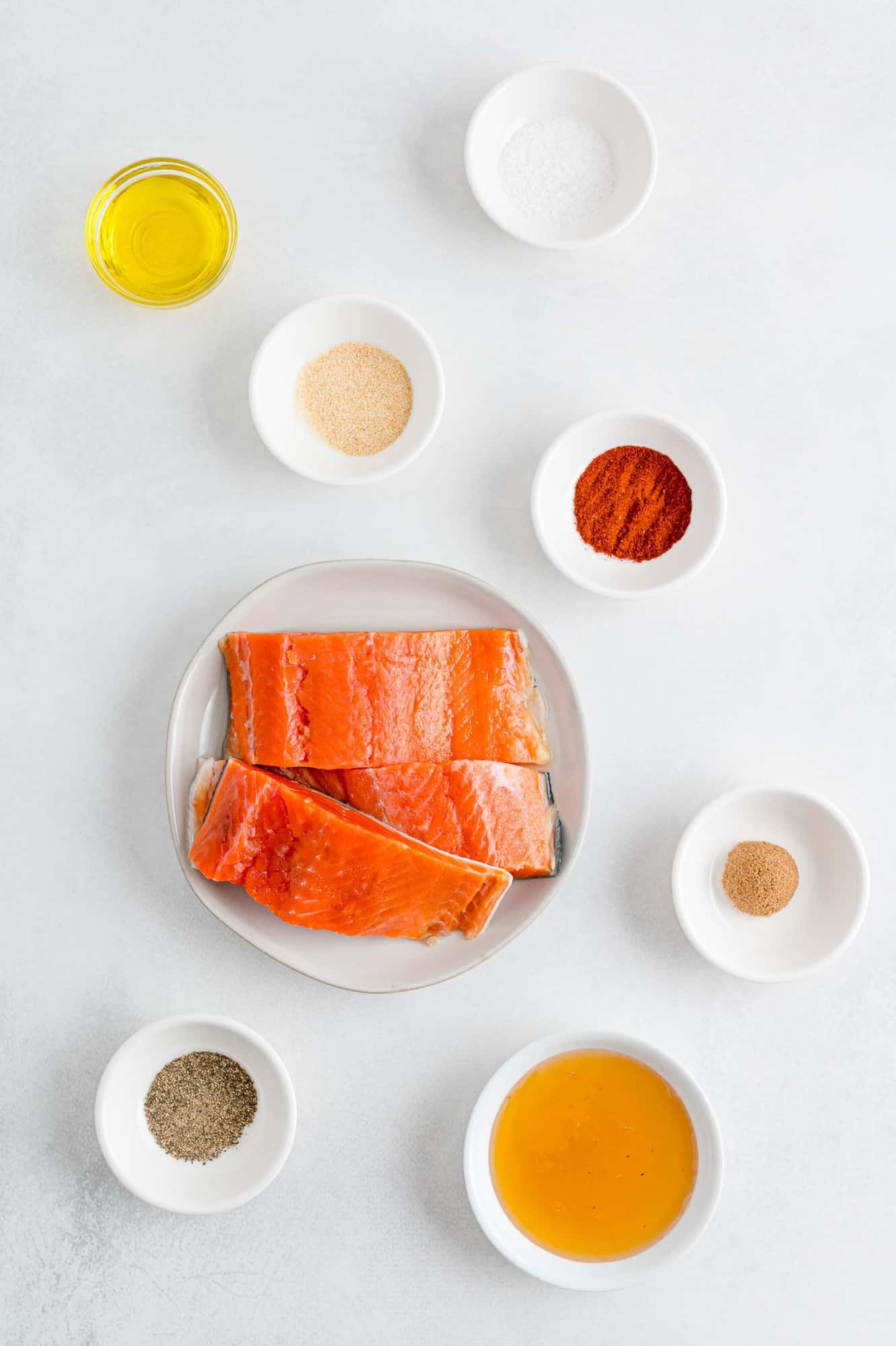 Ingredients for salmon bites in separate dishes, including salmon.