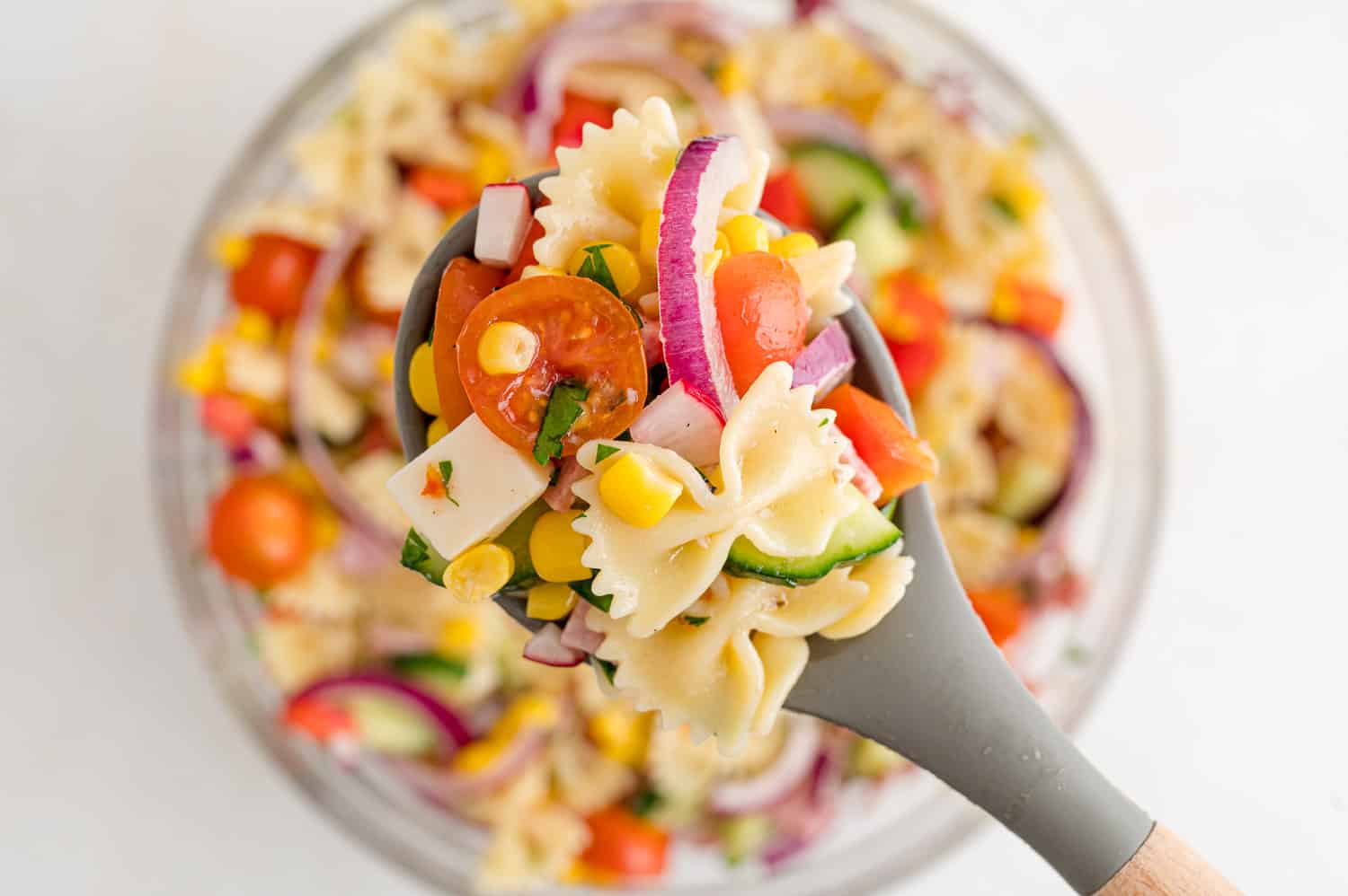 Summer pasta salad on a spoon.