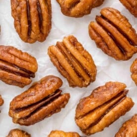 Spiced pecans on a white background.