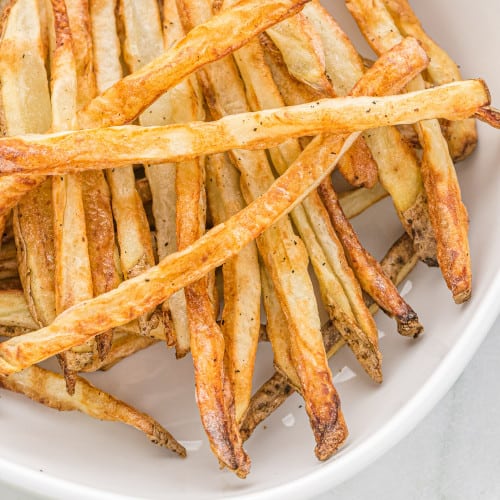 Close up of french fries in a white dish.