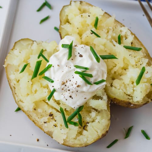 Baked potato with sour cream, chives, and black pepper.
