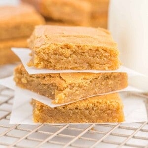Blondies stacked three high with parchment between layers.