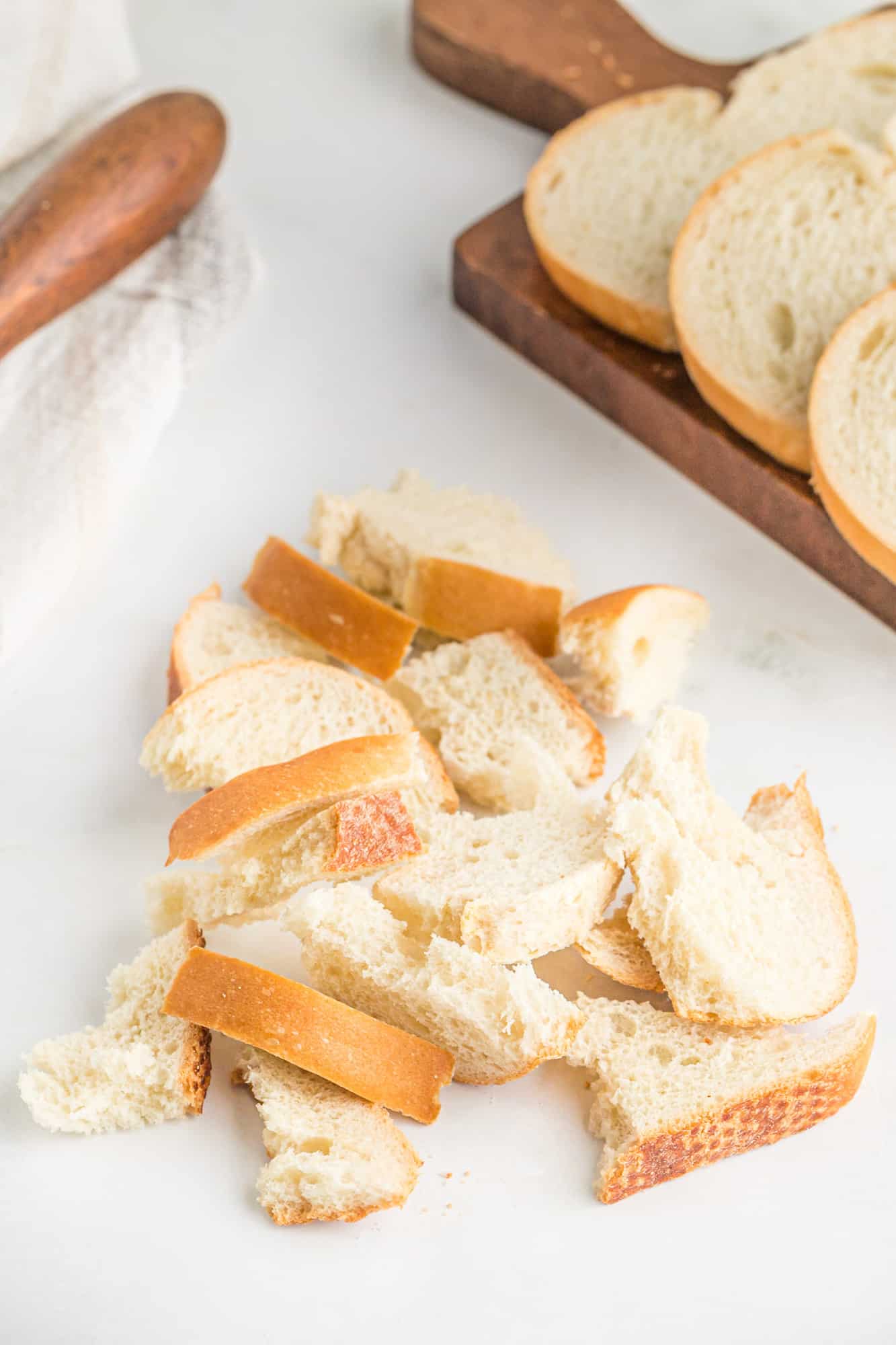 Torn bread on a white surface.