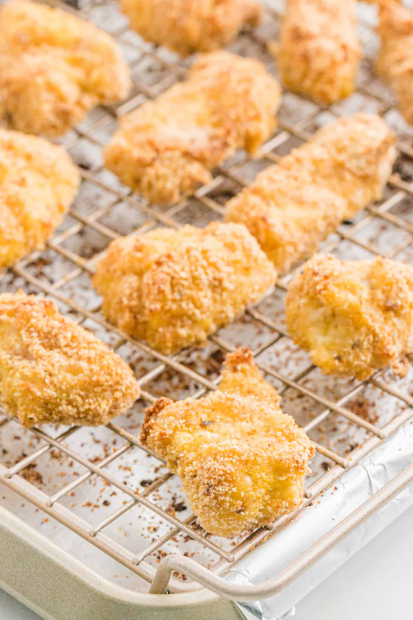 Healthy chicken nuggets on a baking sheet.