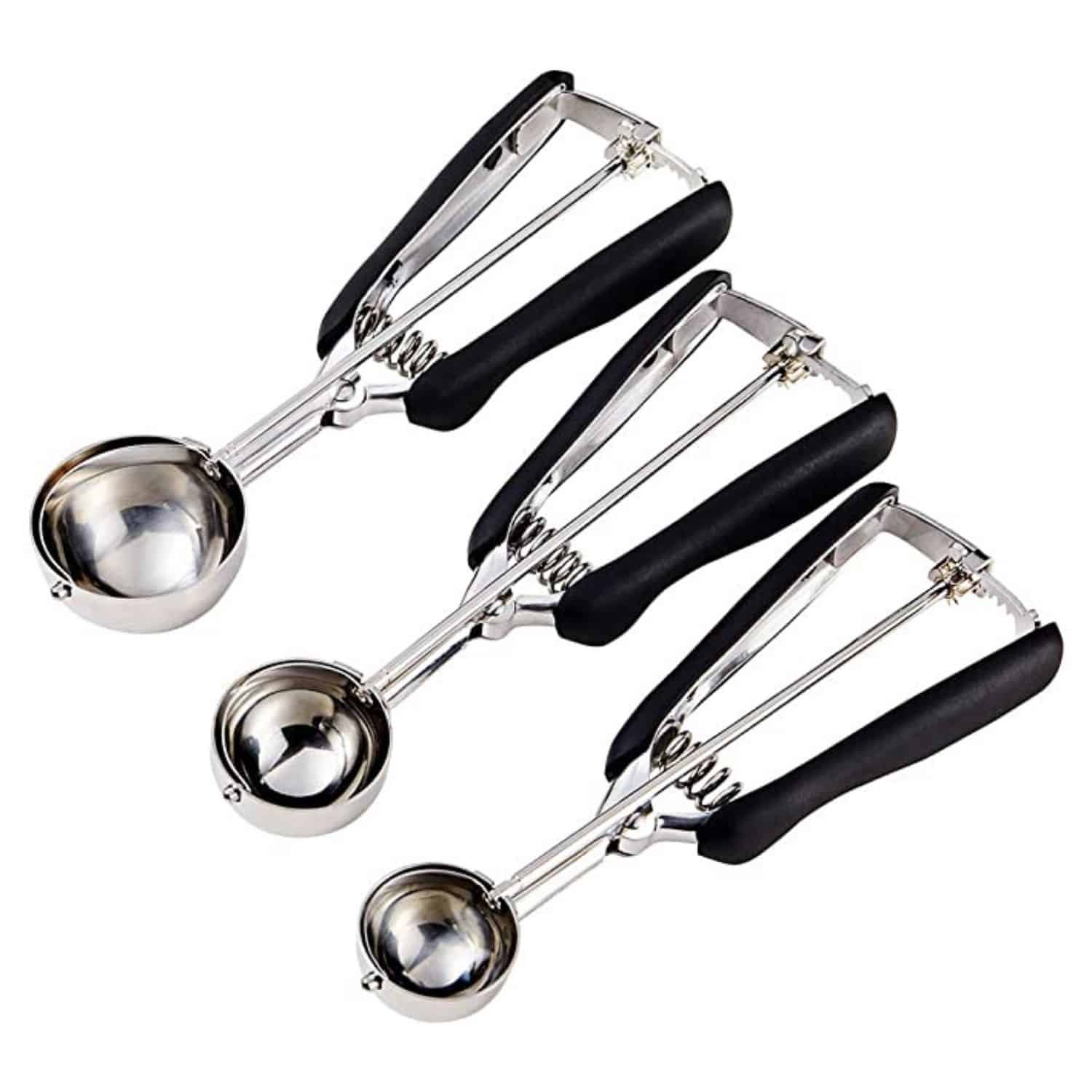 Three cookie scoops on a white background.