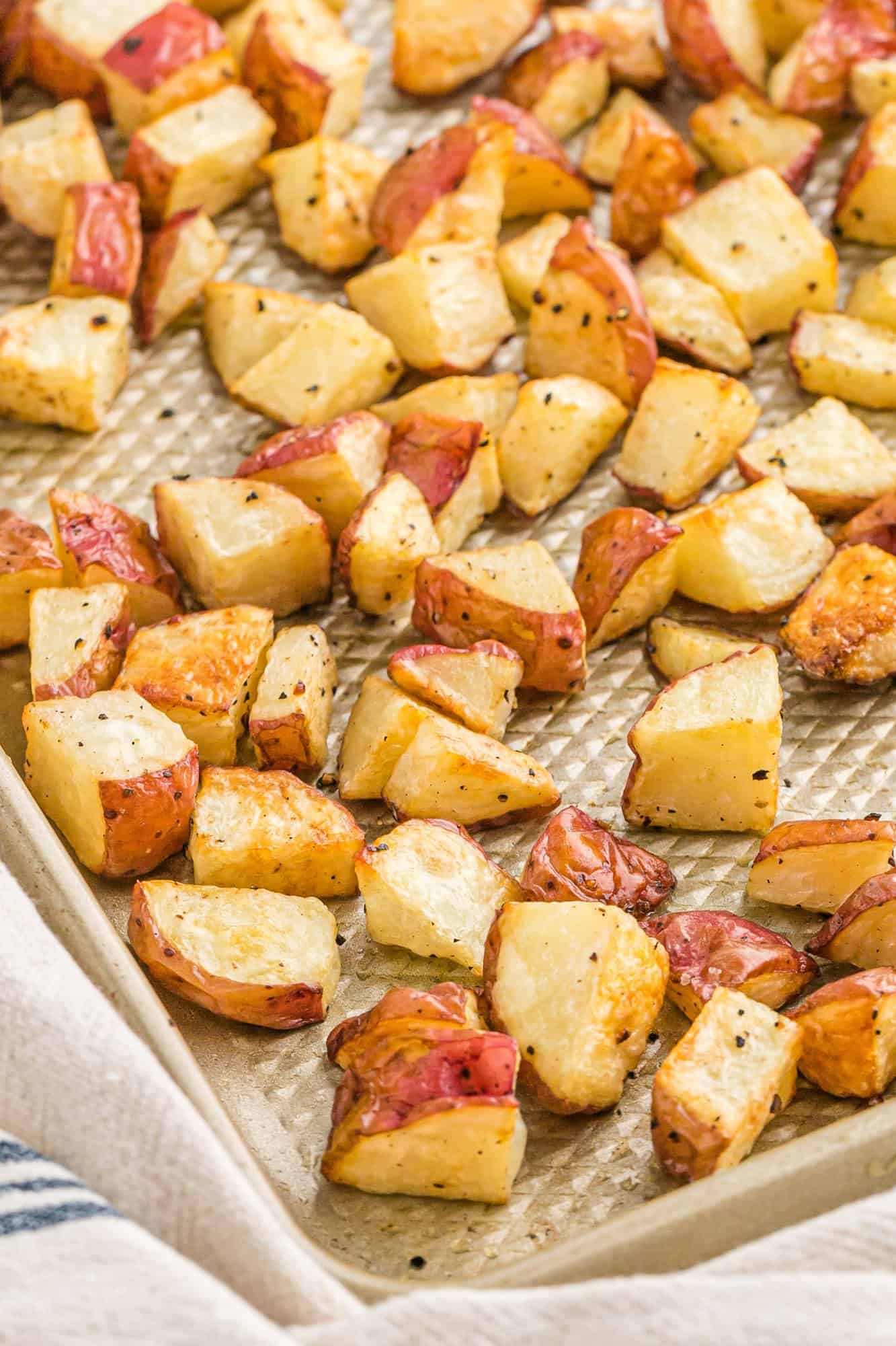 Close up of roasted potatoes on a sheet pan.