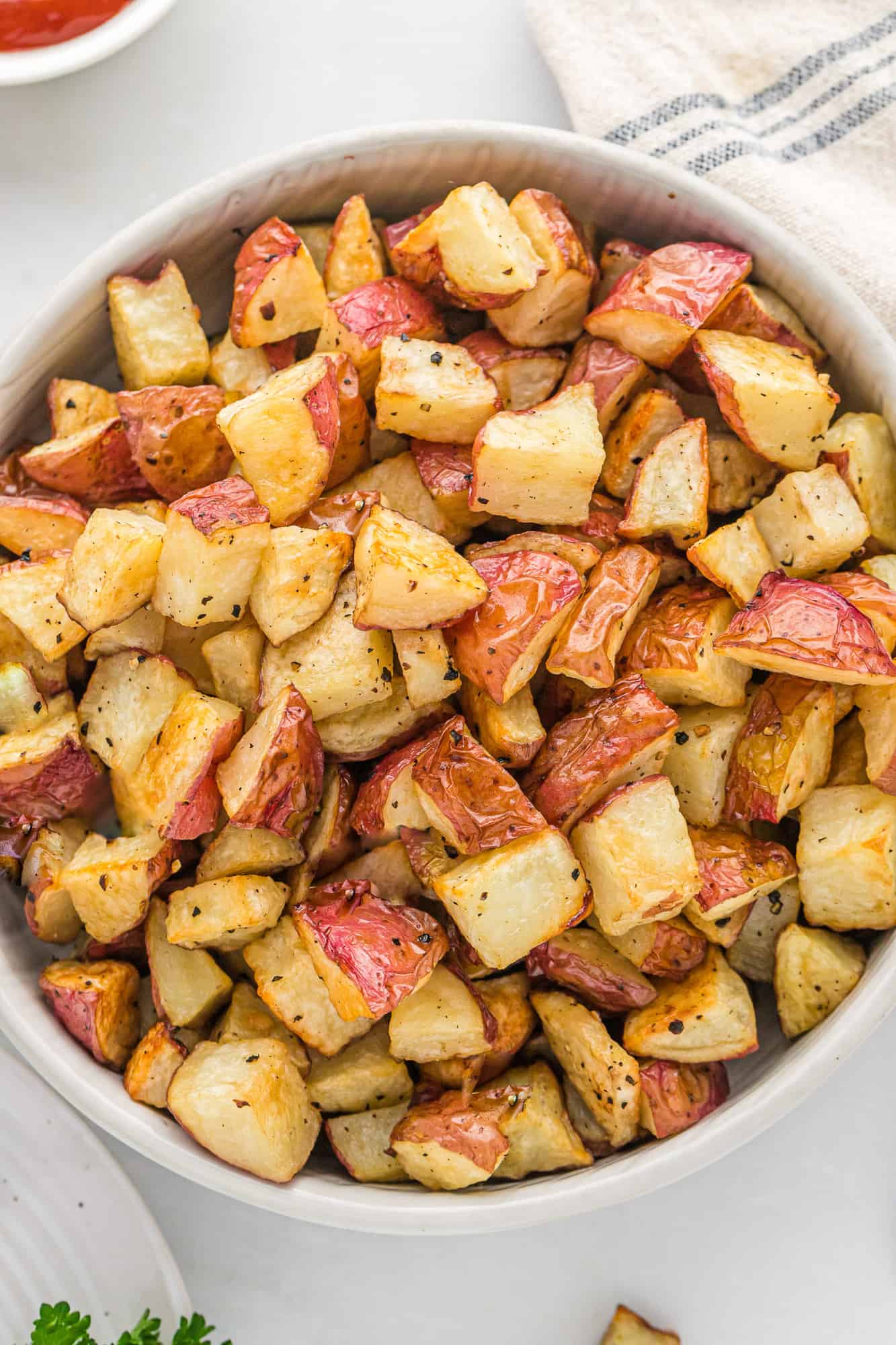 Close up of a large bowl of crispy roasted potatoes.