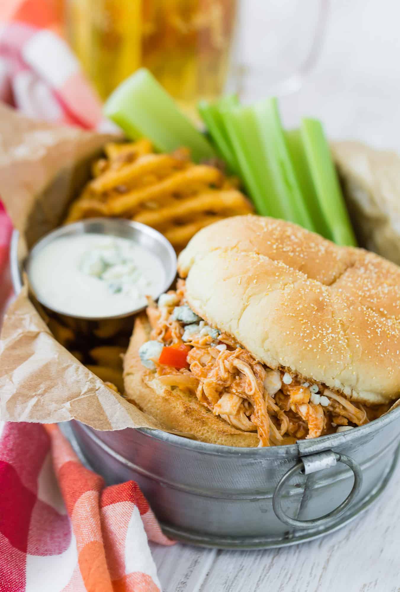 Crockpot buffalo chicken sandwich with fries and celery.