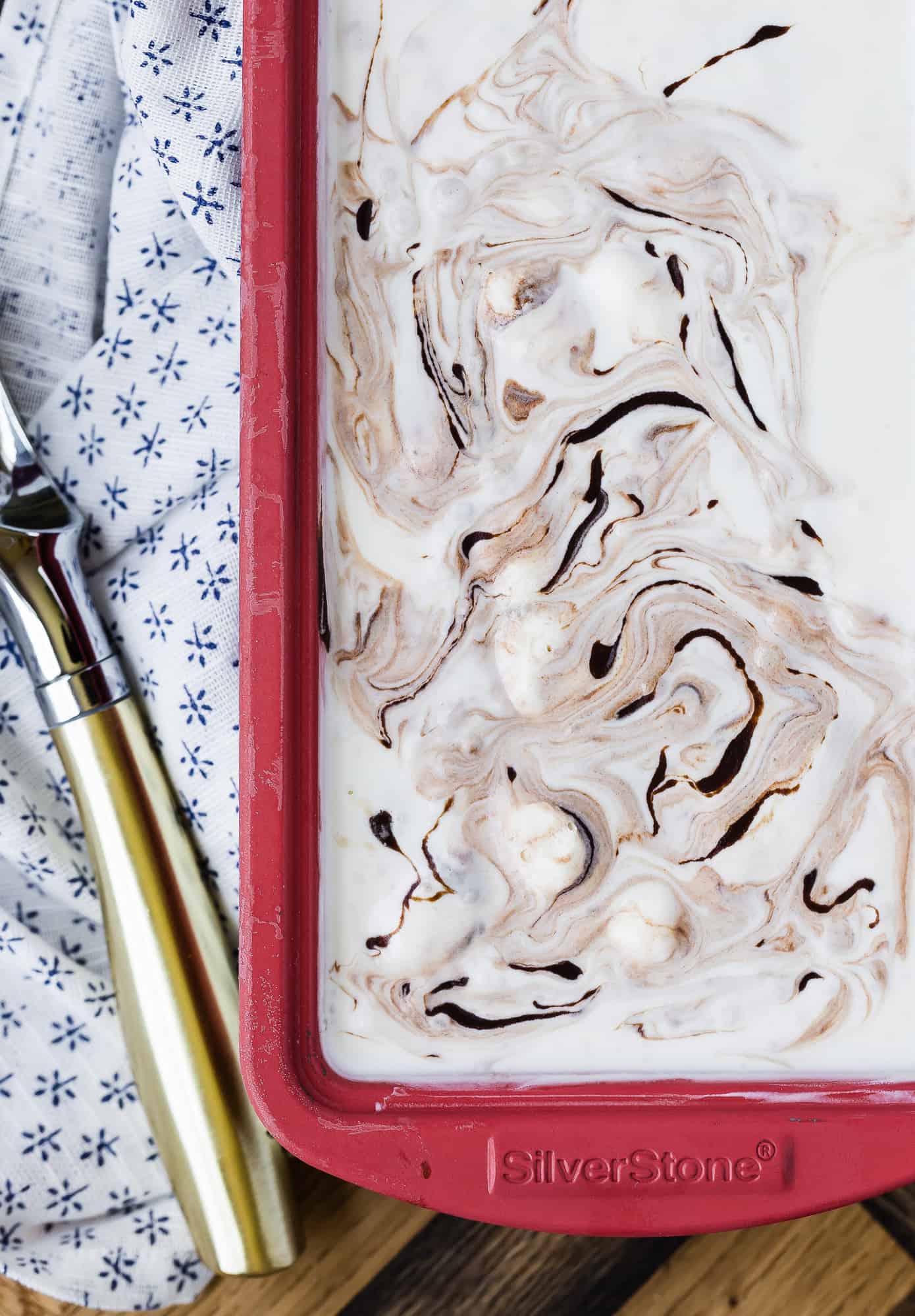 Fudge swirl ice cream in a red loaf pan.