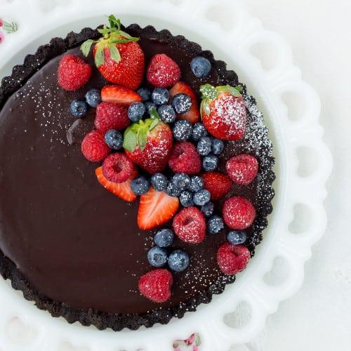 Overhead view of a chocolate tart topped with fruit.