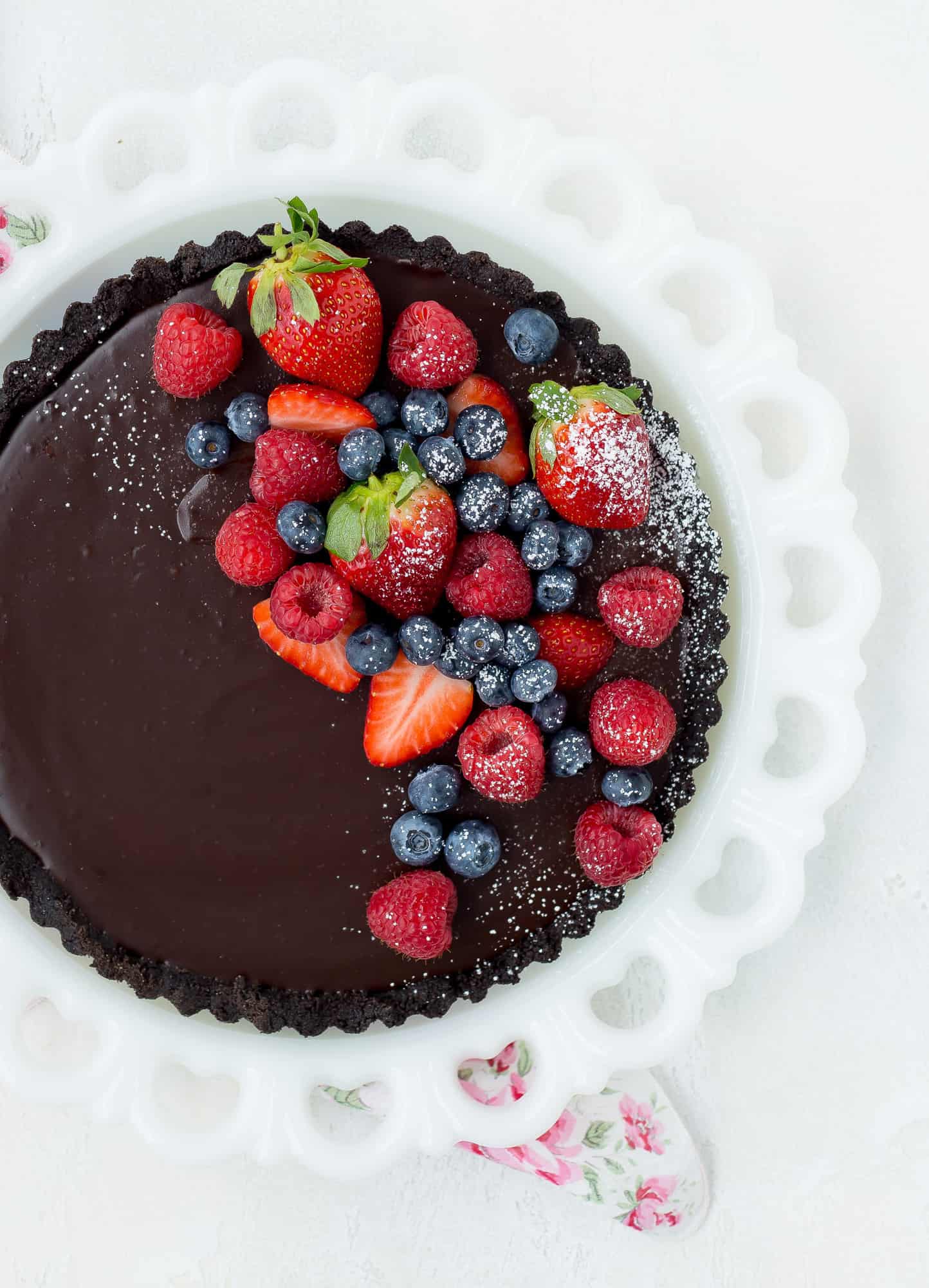 Overhead view of a no bake chocolate tart on a white plate.