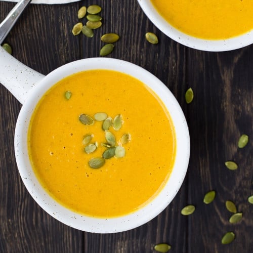 Overhead view of curry pumpkin soup topped with pepitas.