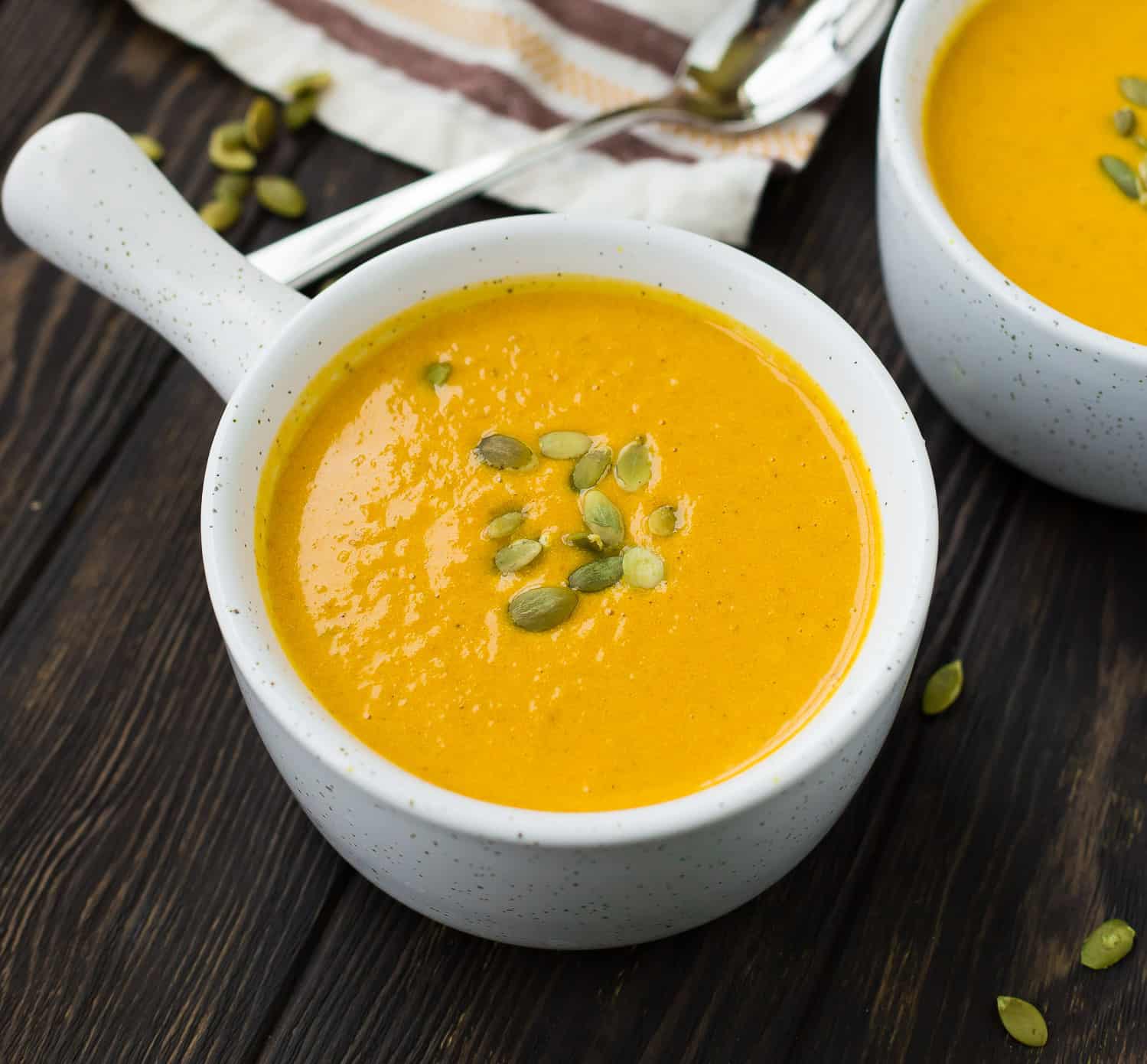 Soup in a white serving bowl with a handle.