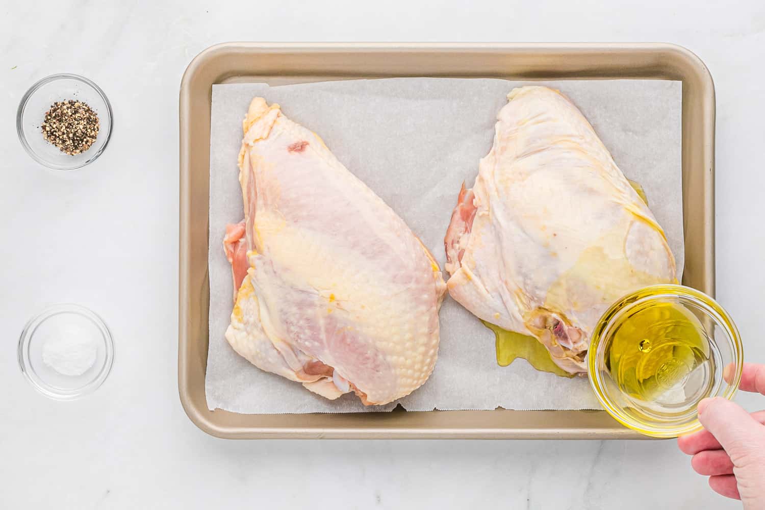 Oil being added to uncooked chicken.