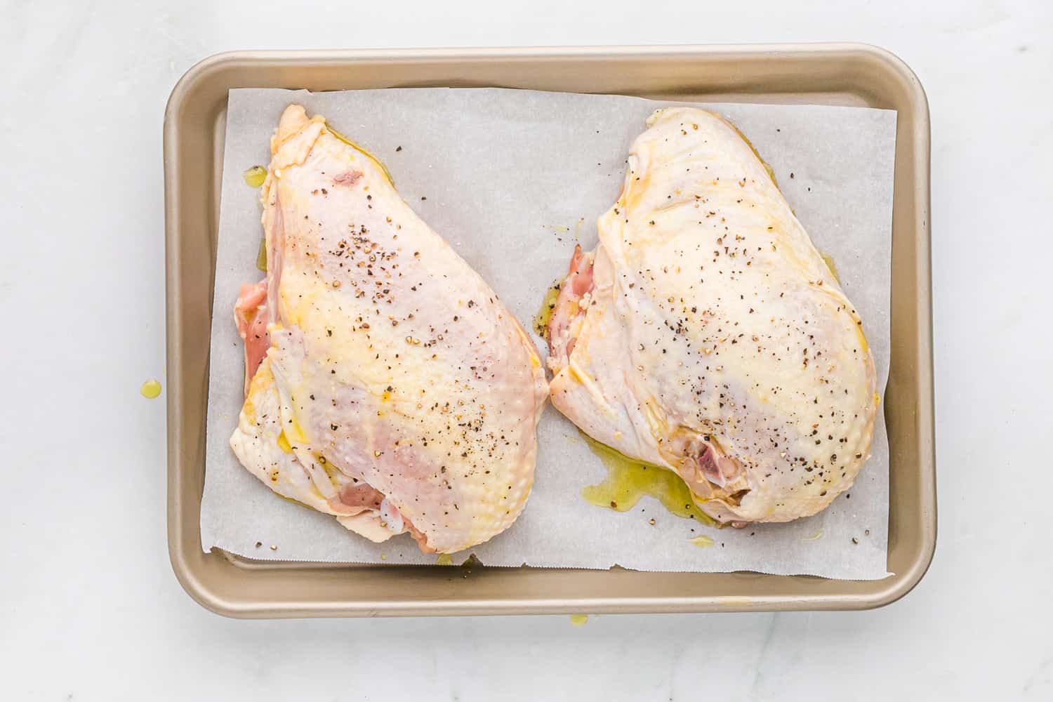 Uncooked chicken with salt and pepper.