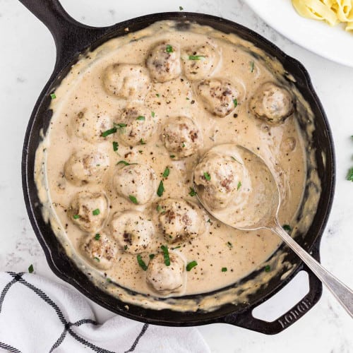 Swedish meatballs in a black cast iron pan.