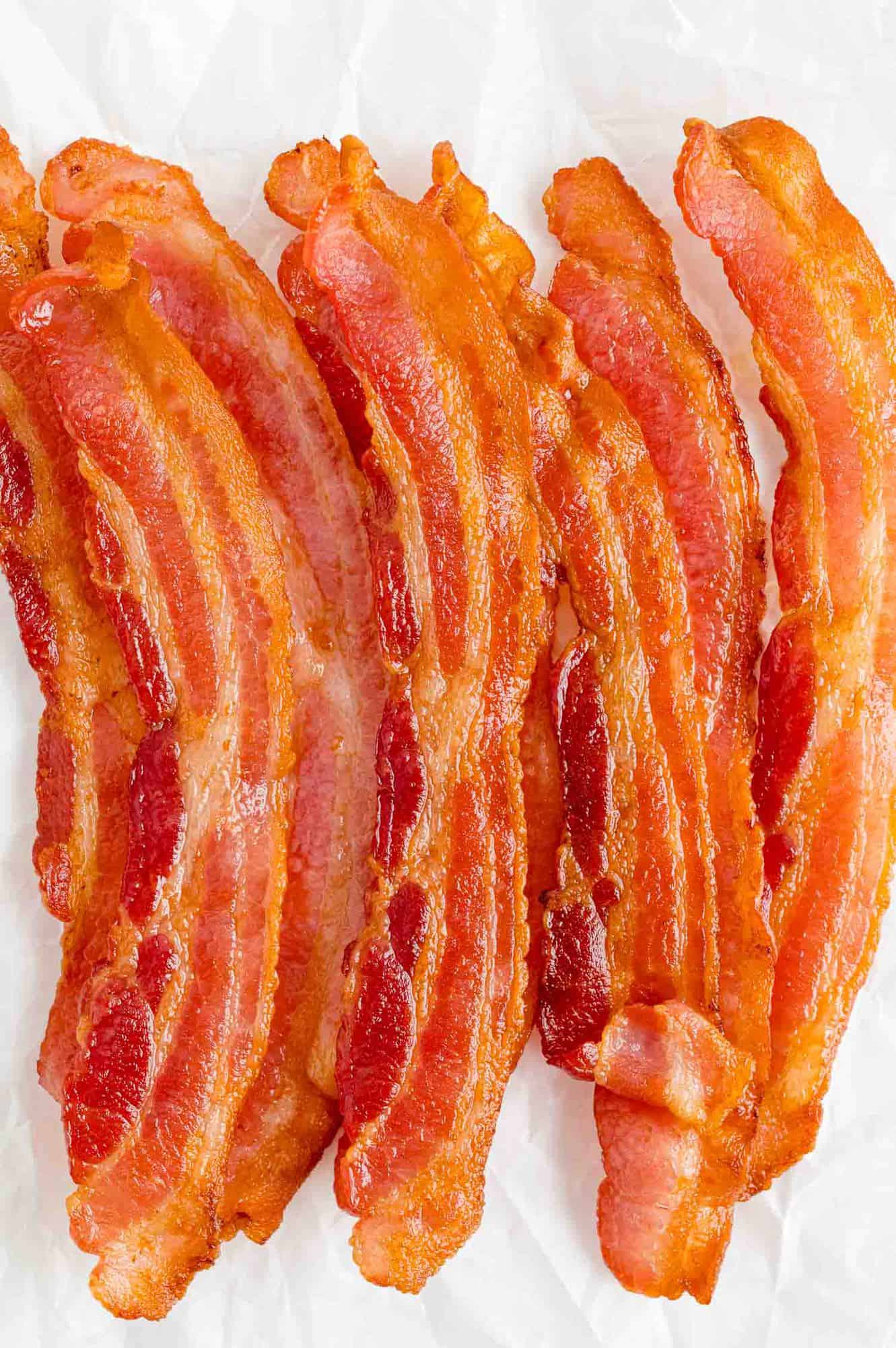 Air fryer bacon on a white background.