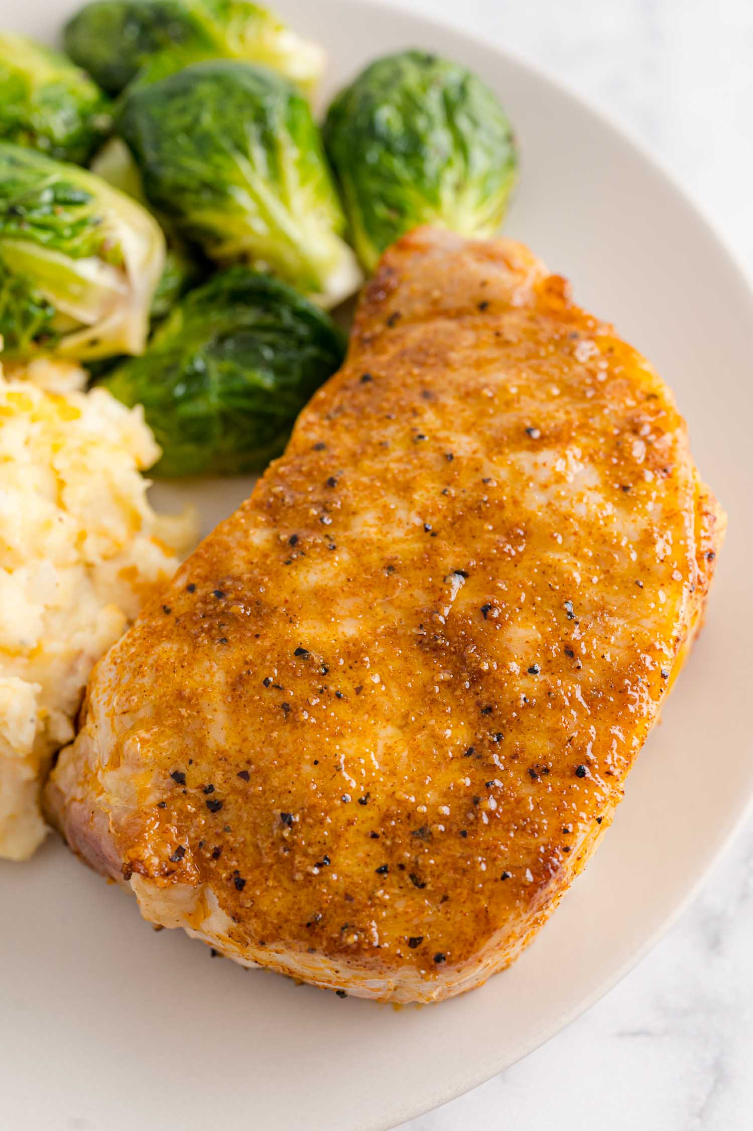 Air fryer pork chop with Brussels sprouts and potatoes.