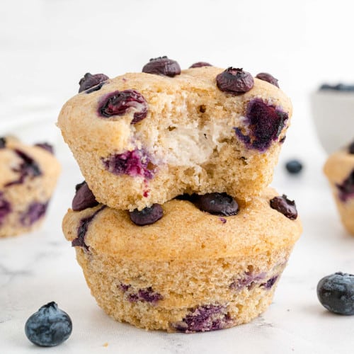 Two blueberry muffins with cream cheese filling.