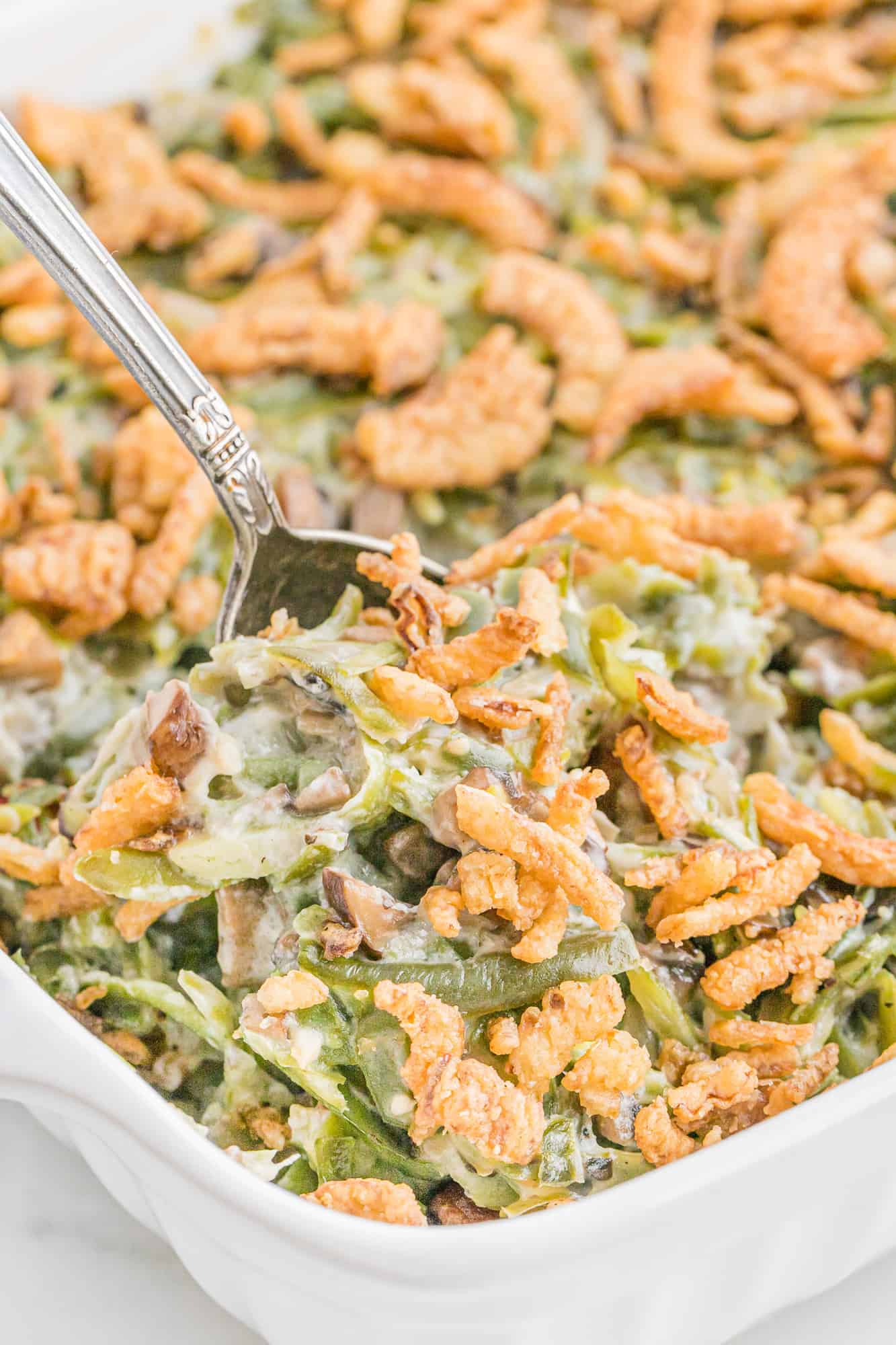 Homemade green bean casserole in white dish.