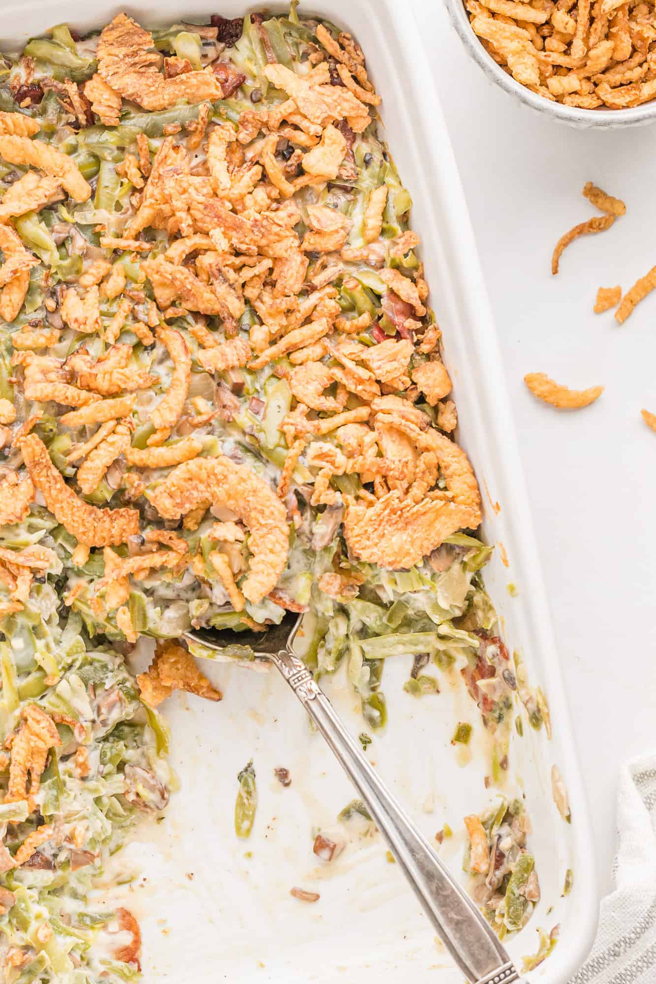 Green bean casserole with scoop removed.