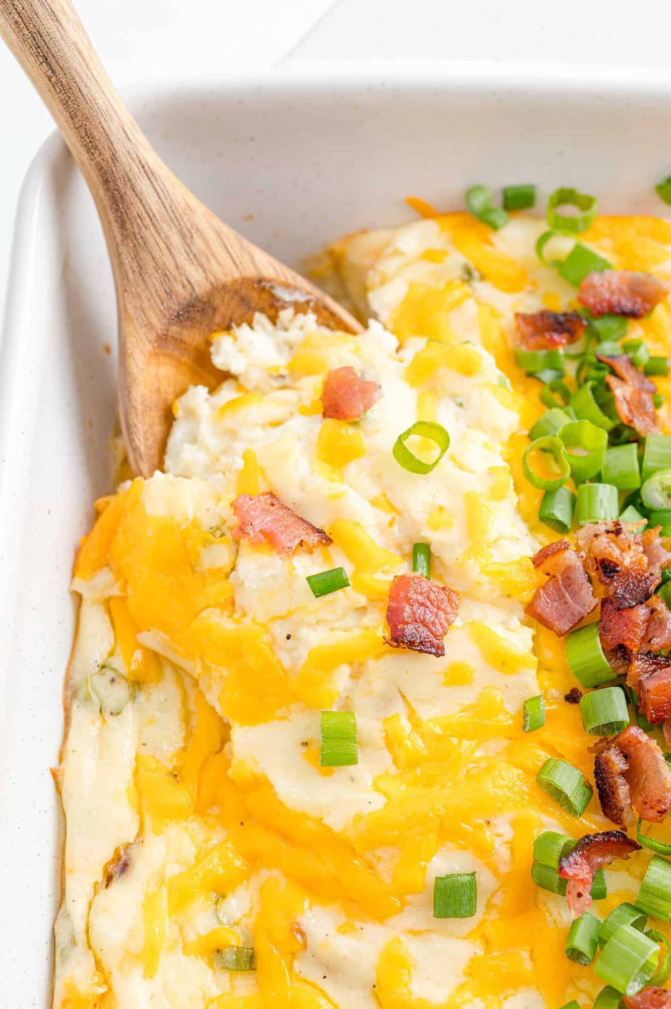 Loaded mashed potatoes in a casserole dish.