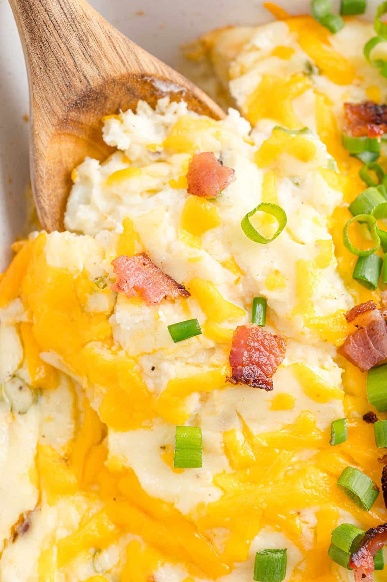 Mashed potato casserole being scooped out.