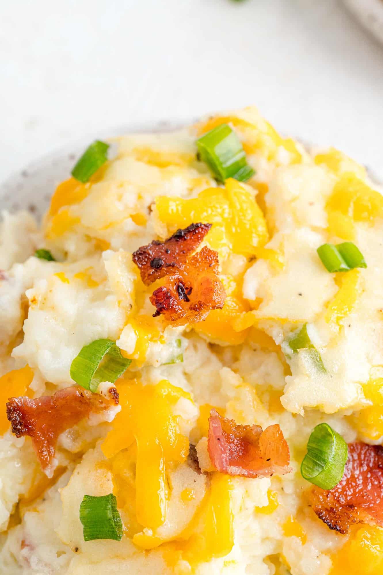 Mashed potatoes with cheese, bacon and green onion.