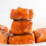 Salmon bites being drizzled with hot honey.