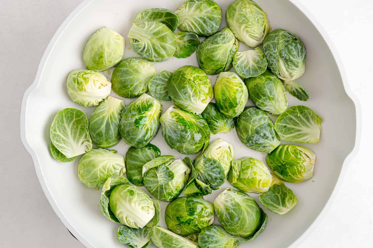 Uncooked Brussels sprouts in a pan.