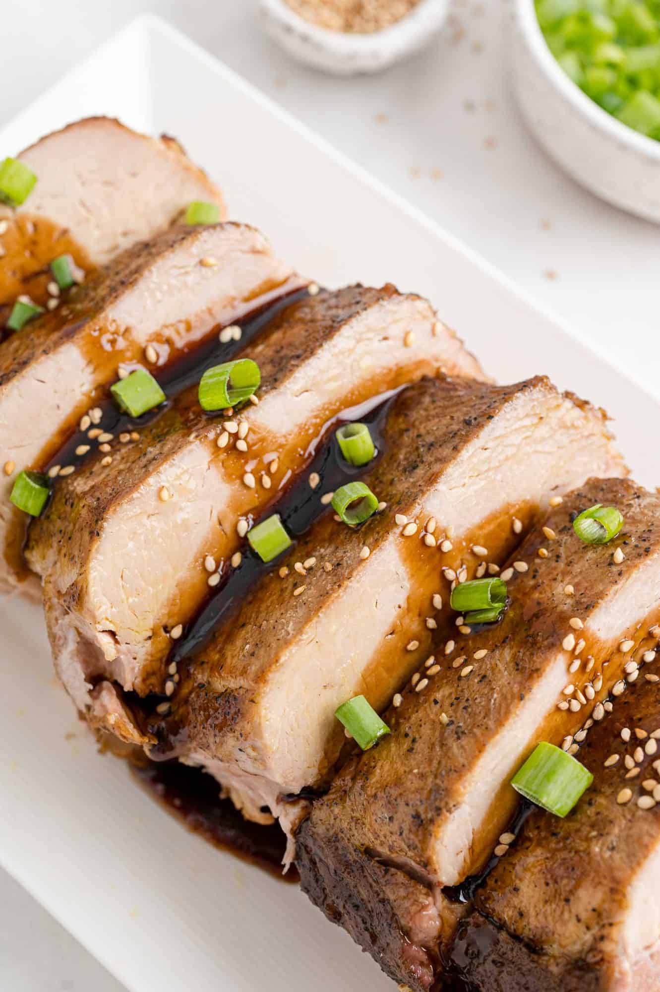 Slow cooker pork loin on a platter with glaze.