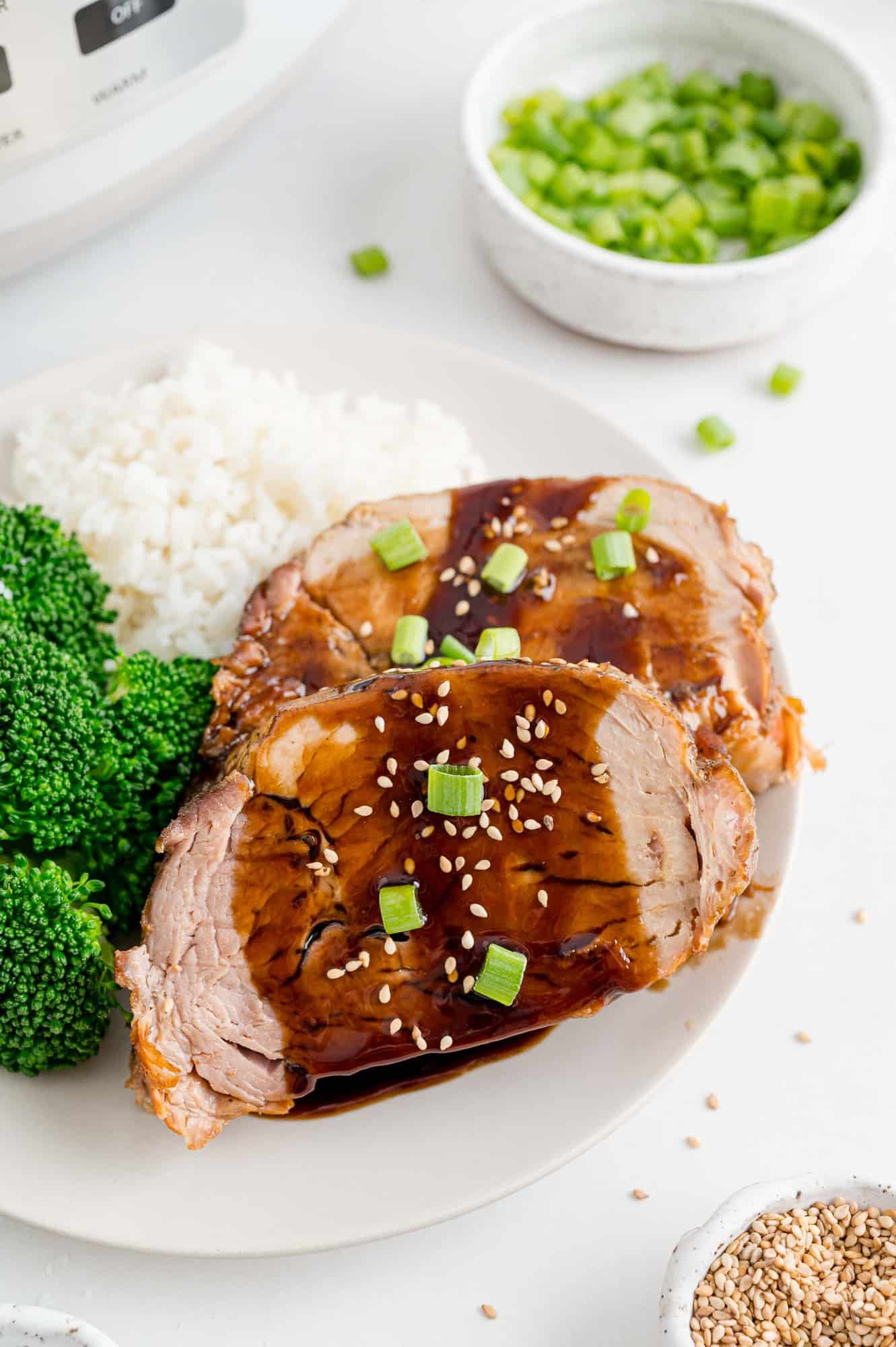 Pork served with broccoli and rice.