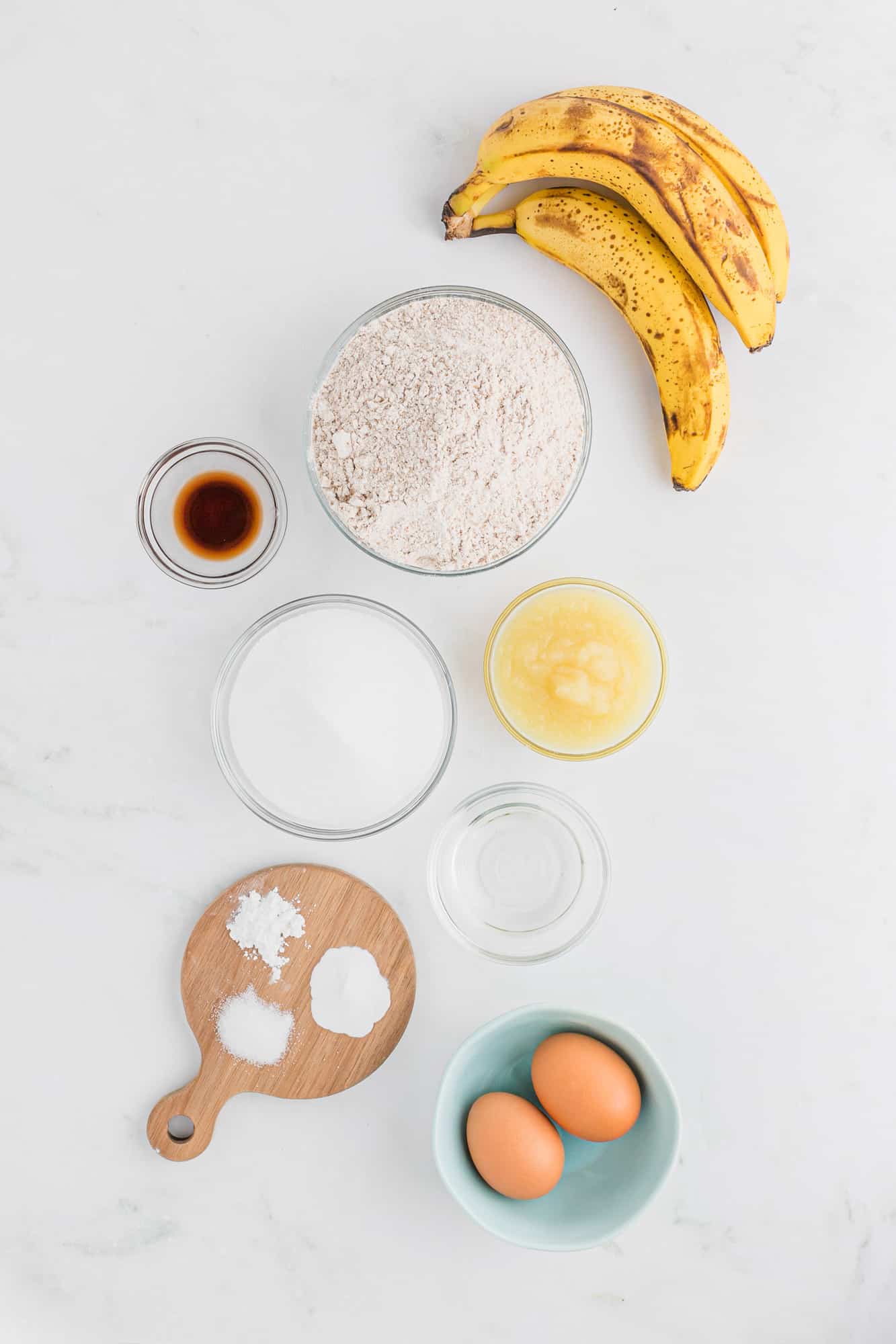 Ingredients in separate dishes, including eggs and bananas.
