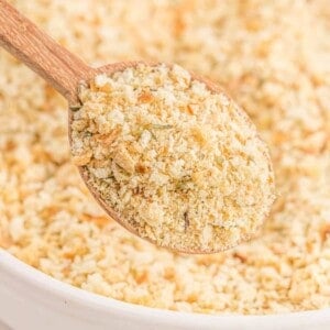 Homemade bread crumbs on a wooden spoon and in a bowl.