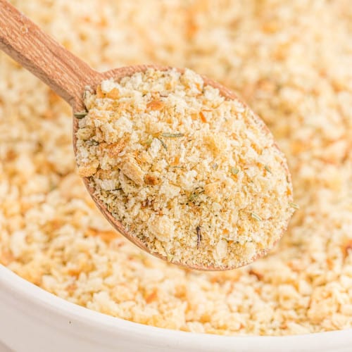 Homemade bread crumbs on a wooden spoon and in a bowl.