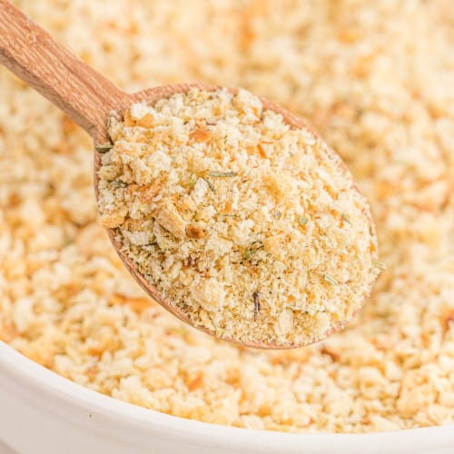 Homemade bread crumbs on a wooden spoon and in a bowl.