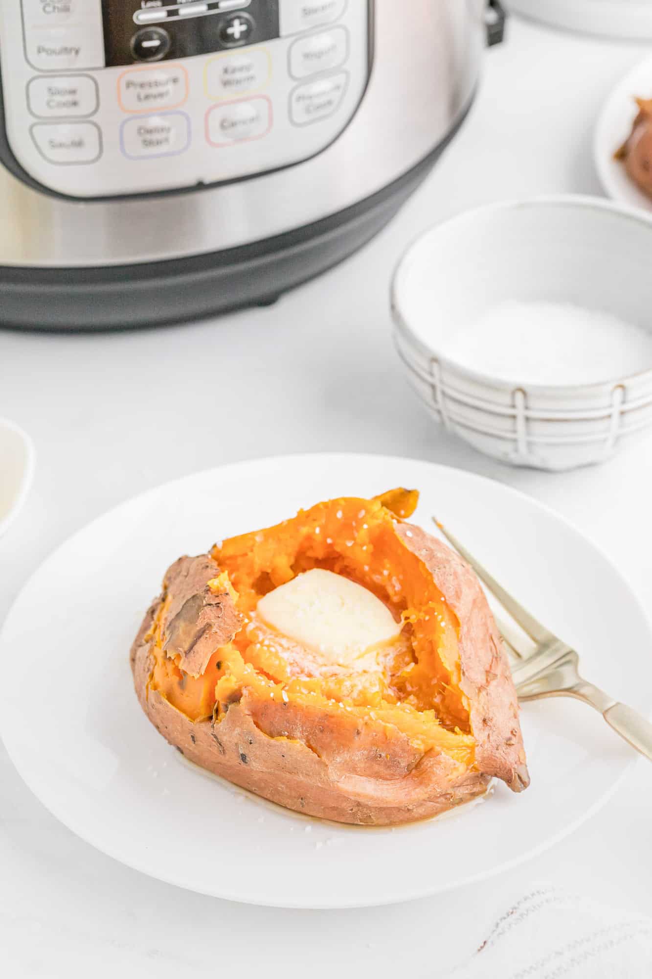 Cooked sweet potato with Instant Pot pressure cooker in background.